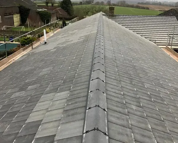 Ridge tile repair work on a tiled roof