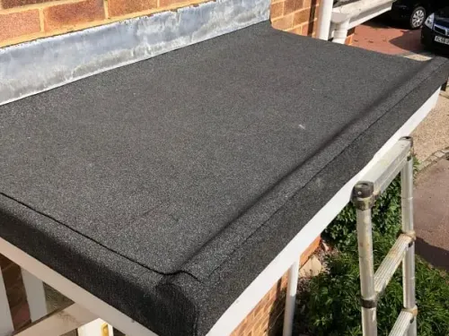 Rubber flat roofing installed above a door